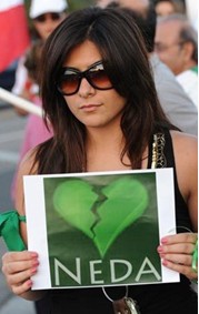 An Iranian woman protesting in Los Angeles holds up a broken heart for slain Iranian protester Neda.